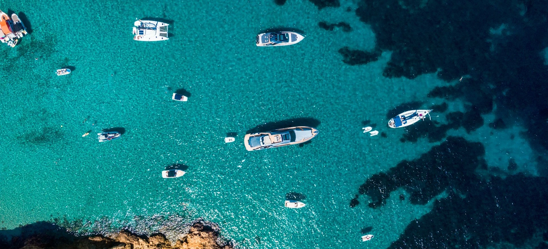 Drone shot of a beautiful beach with yachts